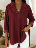 Woman wearing a wine red retro denim top with shawl collar
